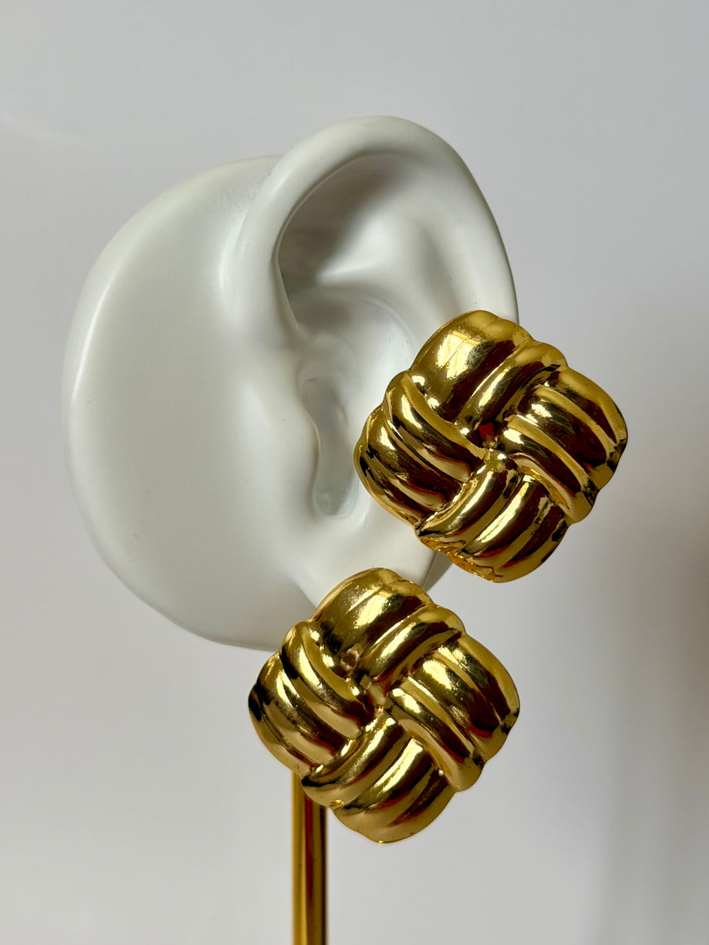 Naya Earrings worn on ear – gold statement earrings