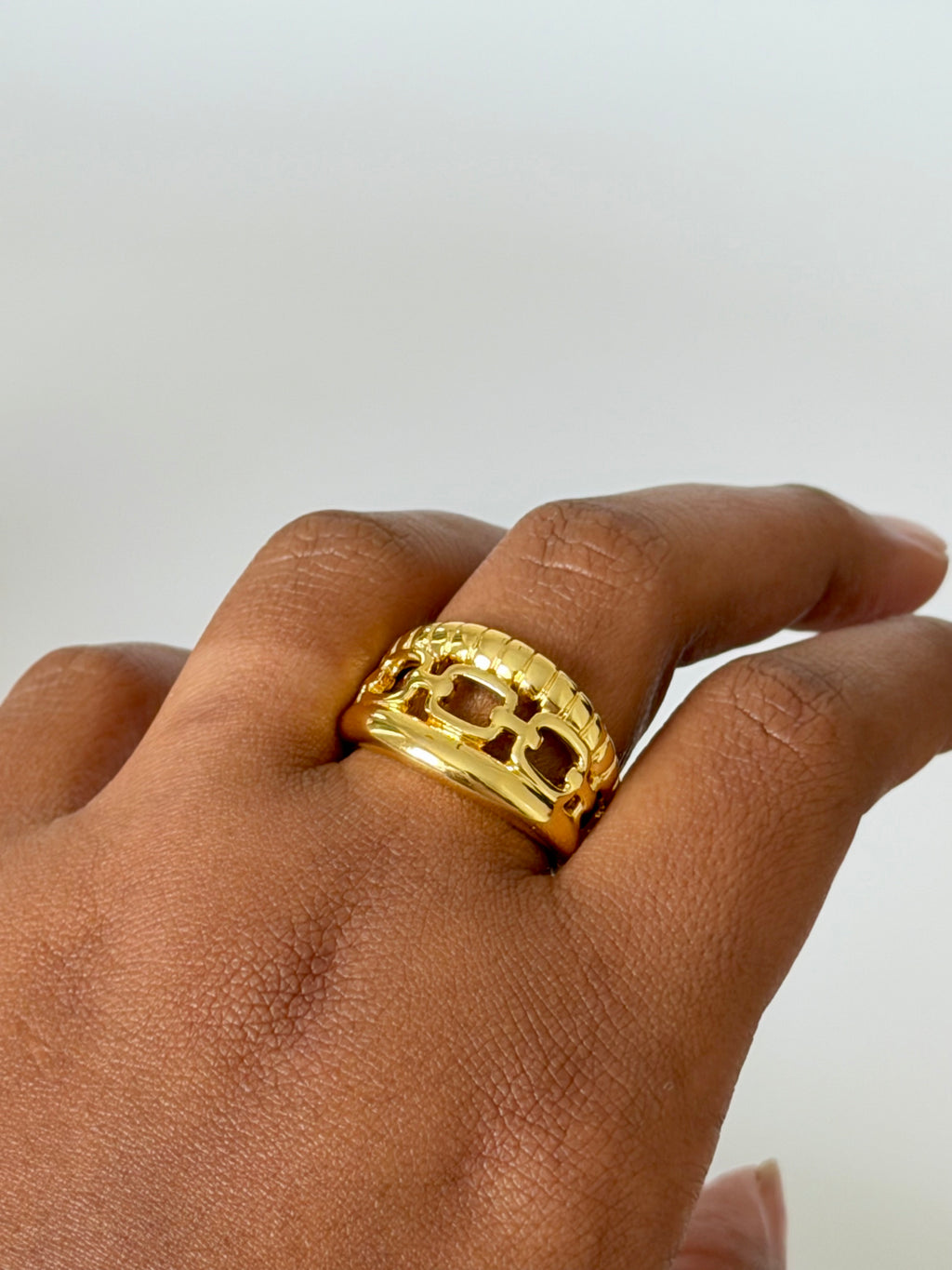 Gold-tone adjustable statement ring worn on hand