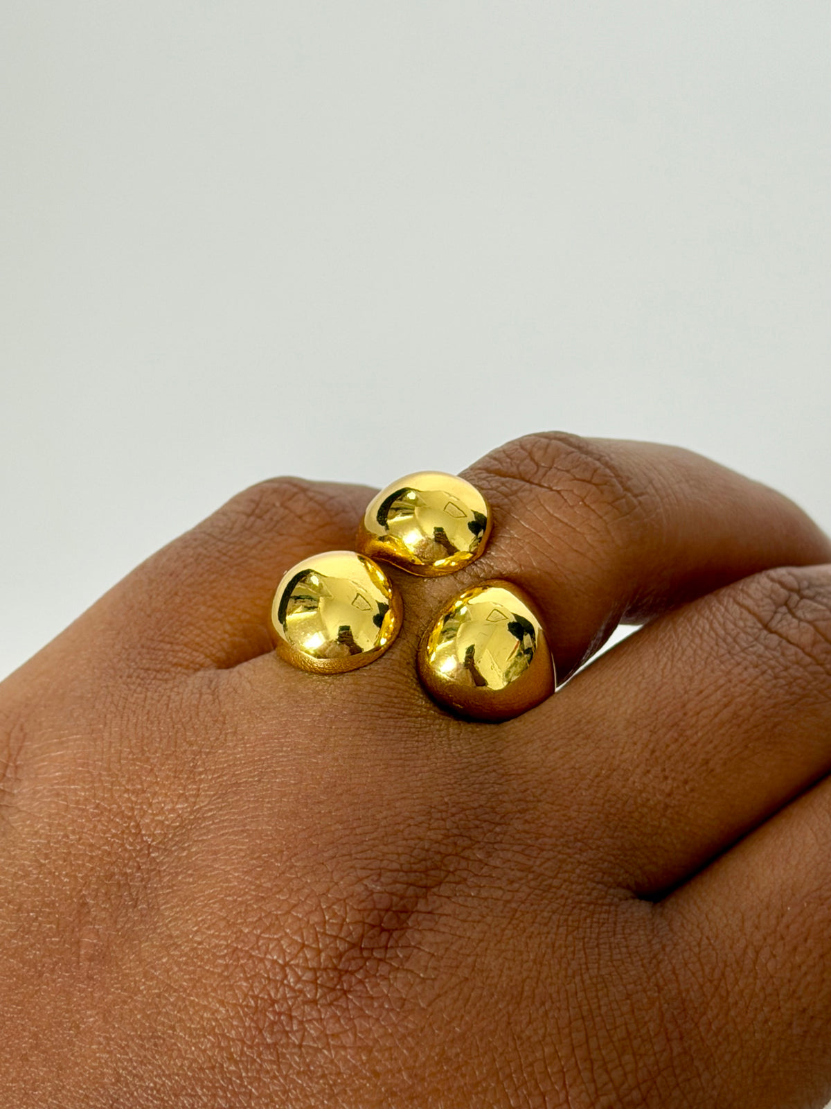 Mira gold statement ring worn on hand