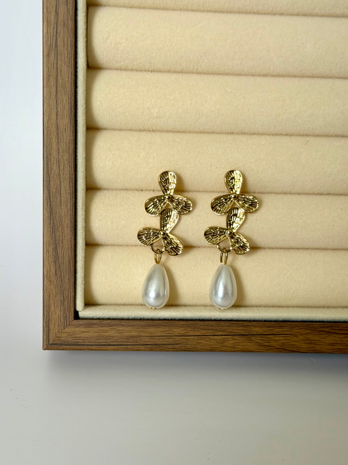 Elodie gold floral pearl earrings displayed in jewellery box